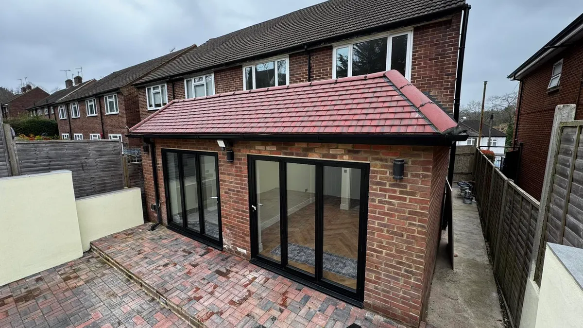 Front view of completed rear extension with tiled roof and bifold doors