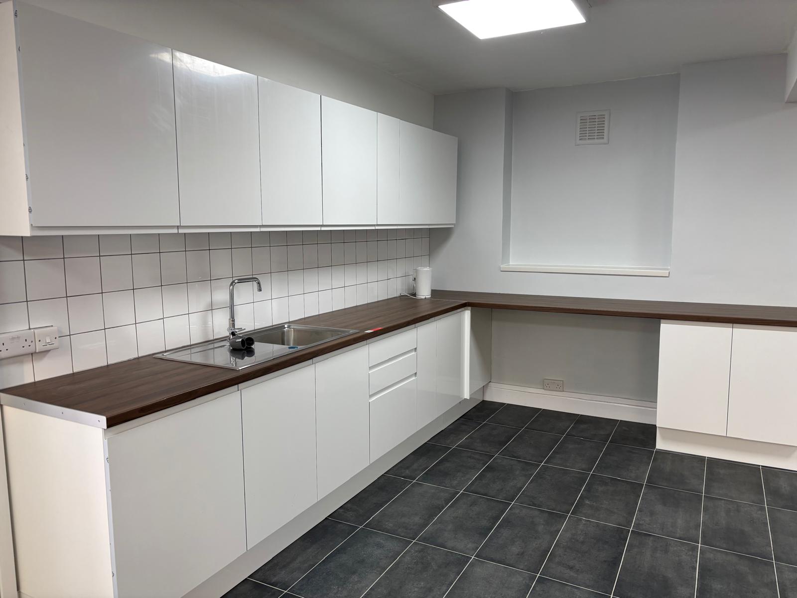 Commercial kitchen fit-out with fitted white units