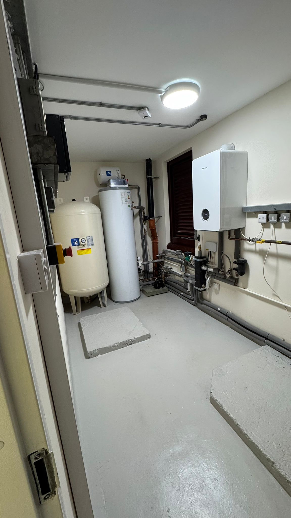 Boiler and hot water cylinder installation in plant room