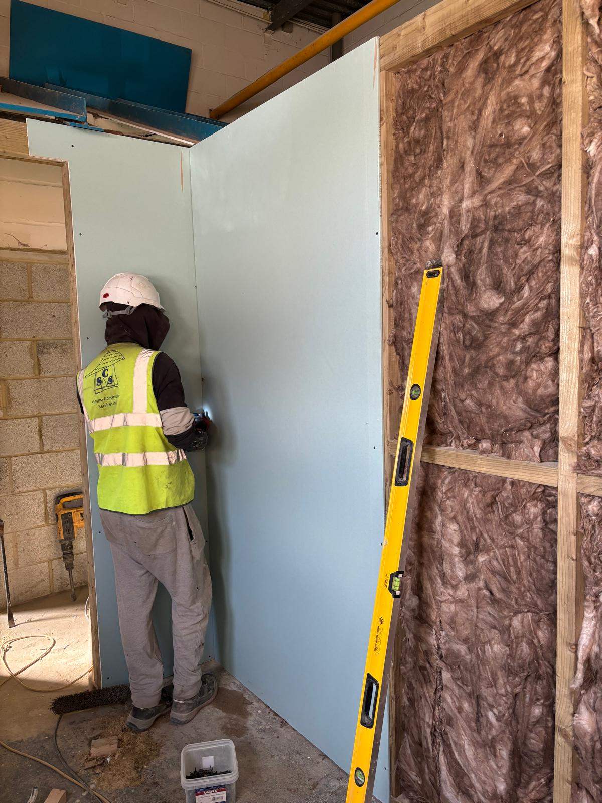 Tradesperson installing an internal partition