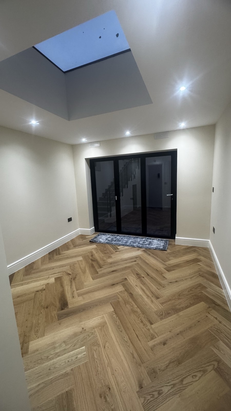Finished reception room with herringbone floor and rooflight